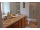 Bathroom with double vanity, walk-in shower, and wood-look floor at 4692 Hillman Ter, North Port, FL 34288