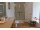 Bathroom with walk-in shower, single vanity, and wood-look floors at 4692 Hillman Ter, North Port, FL 34288