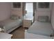 Bedroom with two twin beds, white furniture, and light green bedding at 4692 Hillman Ter, North Port, FL 34288