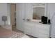 Bedroom featuring white dresser, mirror, and television at 4692 Hillman Ter, North Port, FL 34288