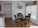 Dining area with a round glass table and four chairs, next to a window at 4692 Hillman Ter, North Port, FL 34288