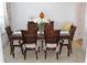 Dining room with wood table, seating for six, and decorative centerpiece at 4692 Hillman Ter, North Port, FL 34288