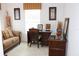 Home office with wicker desk, couch, and decorative accents at 4692 Hillman Ter, North Port, FL 34288