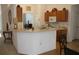 Kitchen with wood cabinets, a breakfast bar, and various decorative items at 4692 Hillman Ter, North Port, FL 34288
