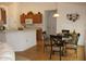 Eat-in kitchen with oak cabinetry, breakfast bar, and dining table at 4692 Hillman Ter, North Port, FL 34288