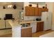 Kitchen with wood cabinetry, stainless steel appliances, and a breakfast bar at 4692 Hillman Ter, North Port, FL 34288
