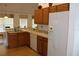 Bright kitchen with wood cabinets, white appliances, and breakfast bar at 4692 Hillman Ter, North Port, FL 34288