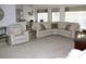 Spacious living room with plush carpeting, large windows, and comfortable seating at 4692 Hillman Ter, North Port, FL 34288