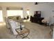 Living room featuring a large TV, ample seating, and access to other rooms at 4692 Hillman Ter, North Port, FL 34288