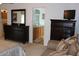 Main bedroom with ensuite bathroom, dark wood furniture and carpet at 4692 Hillman Ter, North Port, FL 34288