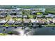 Neighborhood featuring waterfront homes, boat docks, and lush greenery against a scenic horizon at 5541 Almar Dr, Punta Gorda, FL 33950
