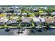 An aerial view of waterfront properties with boat docks on a sunny day surrounded by tropical greenery at 5541 Almar Dr, Punta Gorda, FL 33950