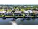 An aerial view of waterfront homes with docks and boat lifts, surrounded by lush greenery and canals at 5541 Almar Dr, Punta Gorda, FL 33950