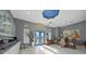 Bright foyer featuring an elegant chandelier, tile flooring, and double doors with glass inserts at 5541 Almar Dr, Punta Gorda, FL 33950