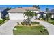 Charming single-story home featuring a brick driveway and landscaping including mature palm trees at 5541 Almar Dr, Punta Gorda, FL 33950