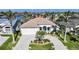 Beautiful waterfront home featuring a brick driveway, a two-car garage, and well-manicured landscaping at 5541 Almar Dr, Punta Gorda, FL 33950