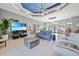 Open-concept living room with tile floors, blue ceiling accents and modern furniture at 5541 Almar Dr, Punta Gorda, FL 33950
