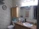 Clean bathroom with single sink vanity, toilet and shower at 6546 Greenview Ct, North Port, FL 34287