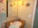 Clean bathroom with single sink vanity and decorative accents at 6546 Greenview Ct, North Port, FL 34287
