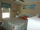 Bedroom with coastal decor, queen-size bed, and window at 6546 Greenview Ct, North Port, FL 34287