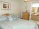 Main bedroom with dresser, ensuite bath access, and ceiling fan at 6546 Greenview Ct, North Port, FL 34287