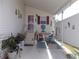 Covered patio with seating area and decorative items at 6546 Greenview Ct, North Port, FL 34287