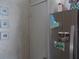 Stainless steel refrigerator in kitchen area with adjacent door and wall decor at 6546 Greenview Ct, North Port, FL 34287