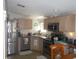Galley kitchen with stainless steel appliances and ample cabinetry at 6546 Greenview Ct, North Port, FL 34287