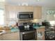Stainless steel microwave and stove top at 6546 Greenview Ct, North Port, FL 34287