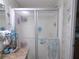 Bathroom shower with glass enclosure and tiled walls at 6546 Greenview Ct, North Port, FL 34287