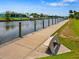 Waterfront walkway with a bench overlooking the canal at 8265 Dafoe St, Port Charlotte, FL 33981