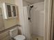 Bathroom featuring a shower, toilet and overhead storage at 11332 8Th Ave, Punta Gorda, FL 33955