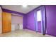 Purple bedroom with tile floors, a ceiling fan, a window, closet and shelving at 11332 8Th Ave, Punta Gorda, FL 33955
