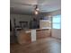 This is the living room with wood floors and a ceiling fan at 11332 8Th Ave, Punta Gorda, FL 33955