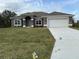 Beautiful one-story home with a two car garage, well manicured lawn, and arched entry at 13346 High Springs Ave, Port Charlotte, FL 33981