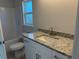 Clean bathroom with white vanity, granite countertop, and a combined tub and shower at 13480 Allentown Ave, Port Charlotte, FL 33981