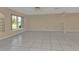 Spacious living room featuring tile floors and large window at 1542 Yorkshire St, Port Charlotte, FL 33952