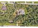 House nestled in a wooded residential area at 1811 Music Ln, North Port, FL 34286