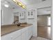 Bathroom features a vanity with a large mirror and access to another room at 1811 Music Ln, North Port, FL 34286