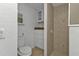 Small bathroom with toilet, shower, and storage at 1811 Music Ln, North Port, FL 34286