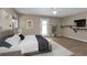 Relaxing bedroom with neutral paint, wood-look floors, decorative shelf, and door to the outside at 1811 Music Ln, North Port, FL 34286