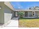 Front entrance with walkway, porch, and landscaping at 1811 Music Ln, North Port, FL 34286