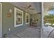 Inviting front porch with ceiling fans, creating a relaxing space at 1811 Music Ln, North Port, FL 34286