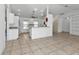 Kitchen with breakfast bar and view into the living room at 1811 Music Ln, North Port, FL 34286
