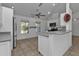 Kitchen with white cabinets, gray countertops, and stainless steel appliances at 1811 Music Ln, North Port, FL 34286