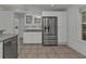 Bright kitchen features stainless steel appliances and white cabinetry at 1811 Music Ln, North Port, FL 34286