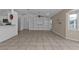 Open living room with built-in shelving and tile floors at 1811 Music Ln, North Port, FL 34286