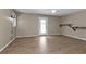 Spacious living room with wood-look flooring and access to patio at 1811 Music Ln, North Port, FL 34286