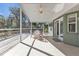 Enjoy this screened porch with a ceiling fan and outdoor dining set at 1811 Music Ln, North Port, FL 34286
