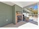 Relaxing screened porch with fireplace and wooden deck overlooking backyard at 1811 Music Ln, North Port, FL 34286